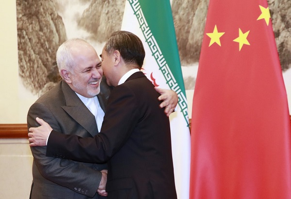 Chinese Foreign Minister Wang Yi (R) shakes hands with Iranian Foreign Minister Mohammad Javad Zarif at the Diaoyutai State Guesthouse in Beijing on August 26, 2019. (Photo by HOW HWEE YOUNG / POOL / AFP)